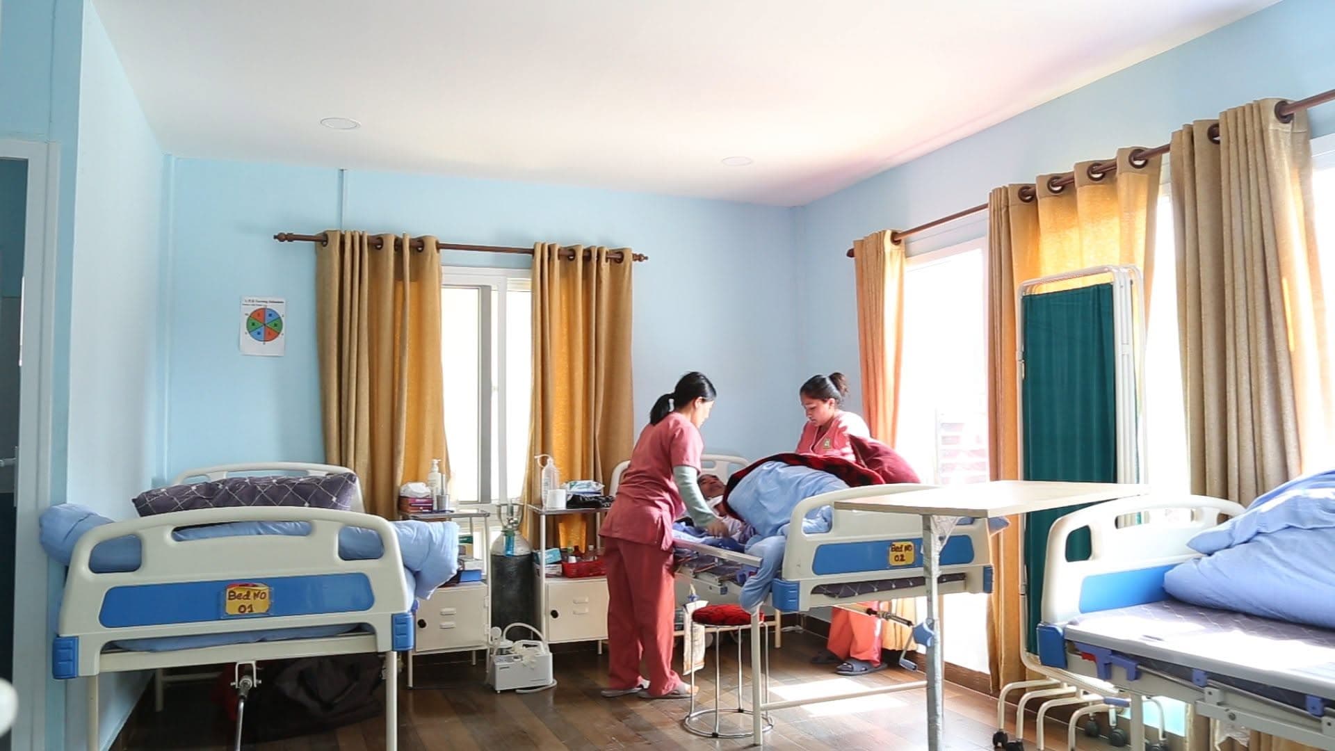 A Naman nurse tending to a resident during the morning round — the daily rhythm of memory and chronic care